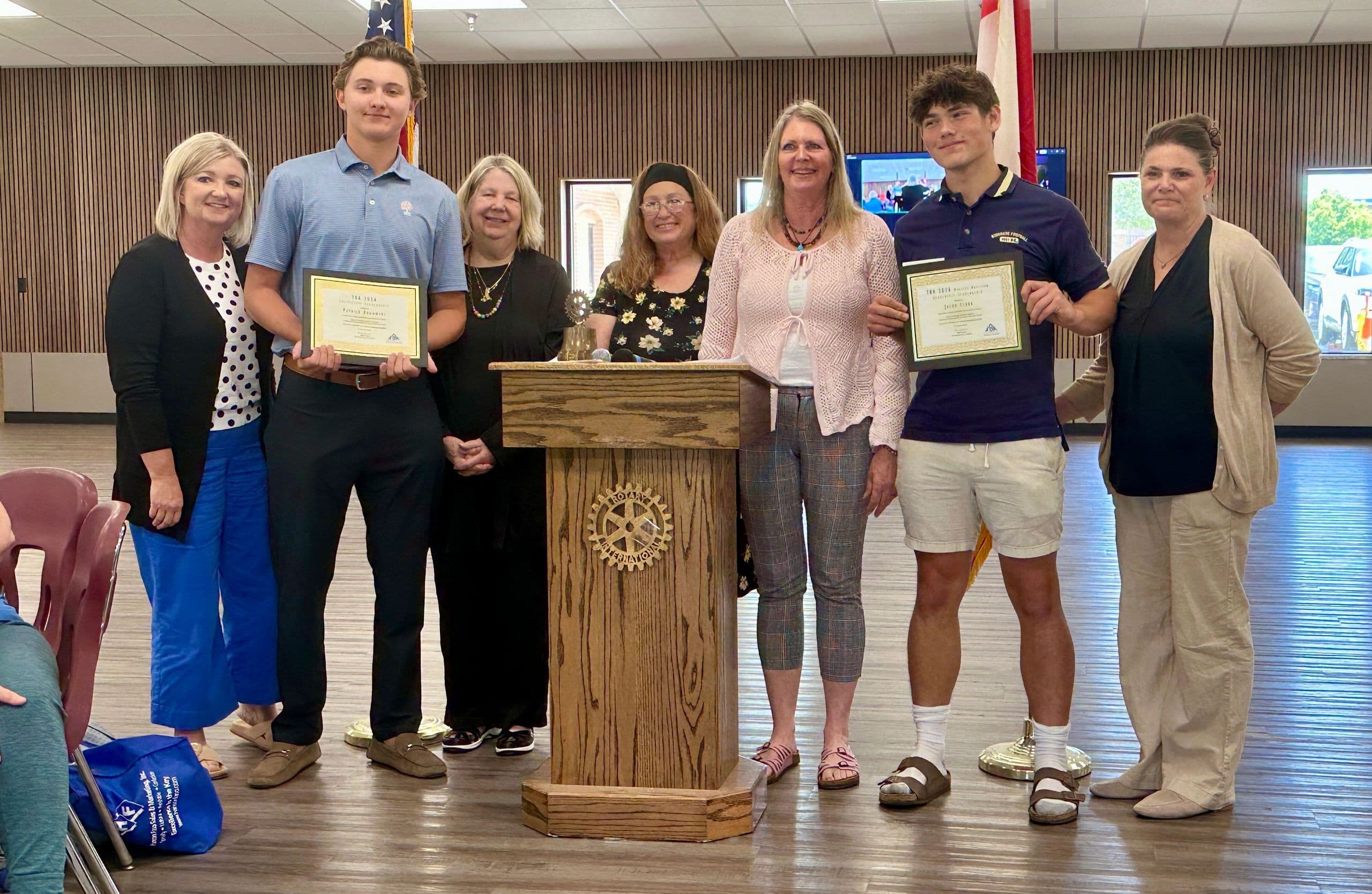 2026 TBA scholarship recipients Jacob Clark and Patrick Rogowski holding their certificates with TBA representatives.